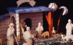 A manger with the newborn Jesus, Mary, Joseph and shepherds.